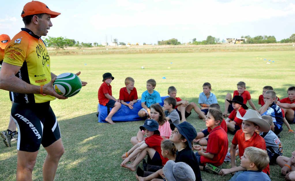 NRL referee Ben Cummins talks to school kids in Rolleston during his charity bike ride around Central Queensland. NRL referee Ben Cummins talks to school kids in Rolleston during his charity bike ride around Central Queensland.